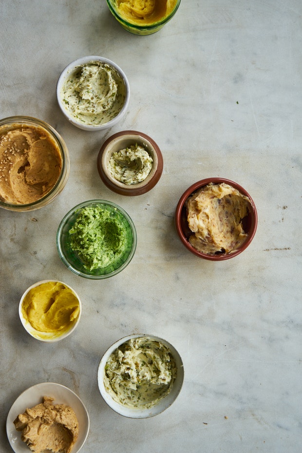 An assortment of compound butters on a counter