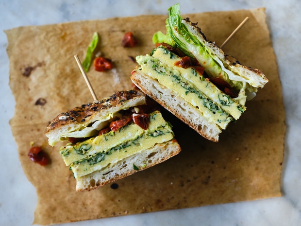 a frittata sandwich on parchment paper