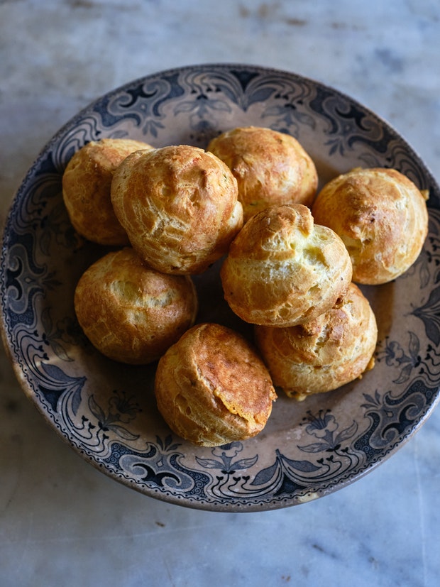 Gougeres piled high on a small plate