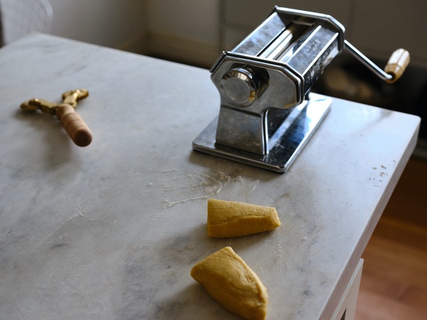 Pappardelle dough next to an Atlas Pasta machine