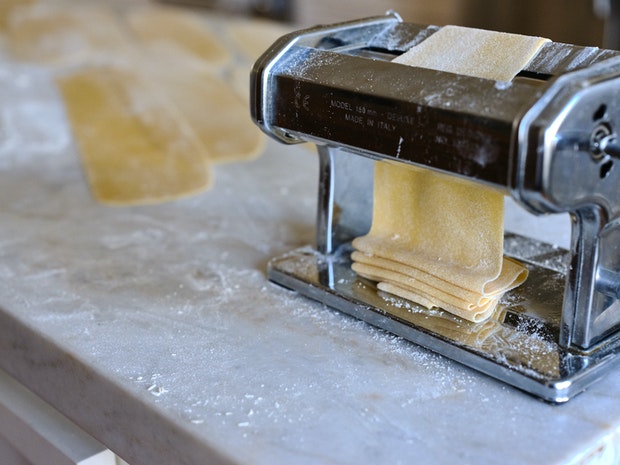 Pasta machine making sheets of pasta dough from which you cut pappardelle