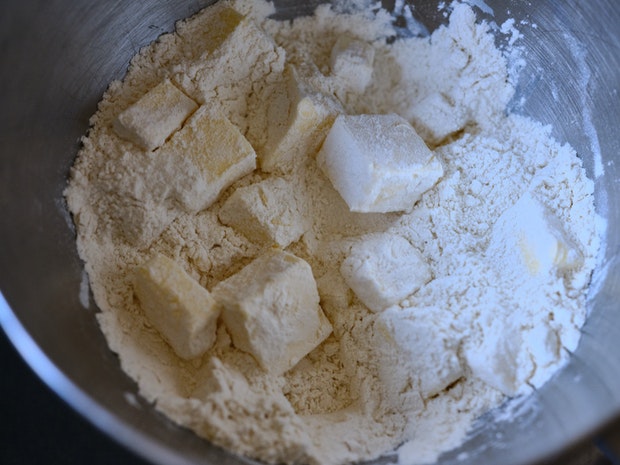 cubes of butter coated with flour in a bowl