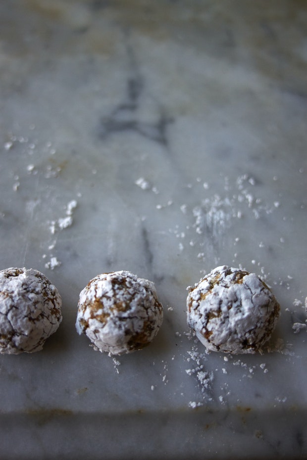 small pistachio cookies on marble counter