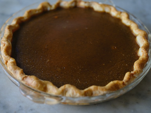 freshly baked pumpkin pie in glass pie plate