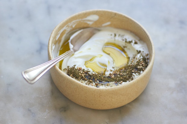 za'atar in a mortar with a pestle to blend